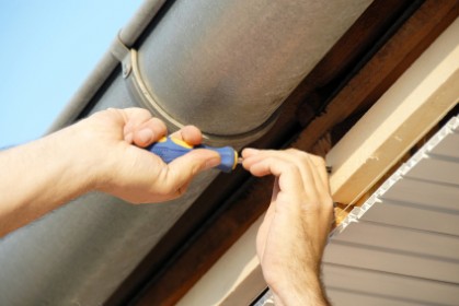 A person installing ceiling insulation